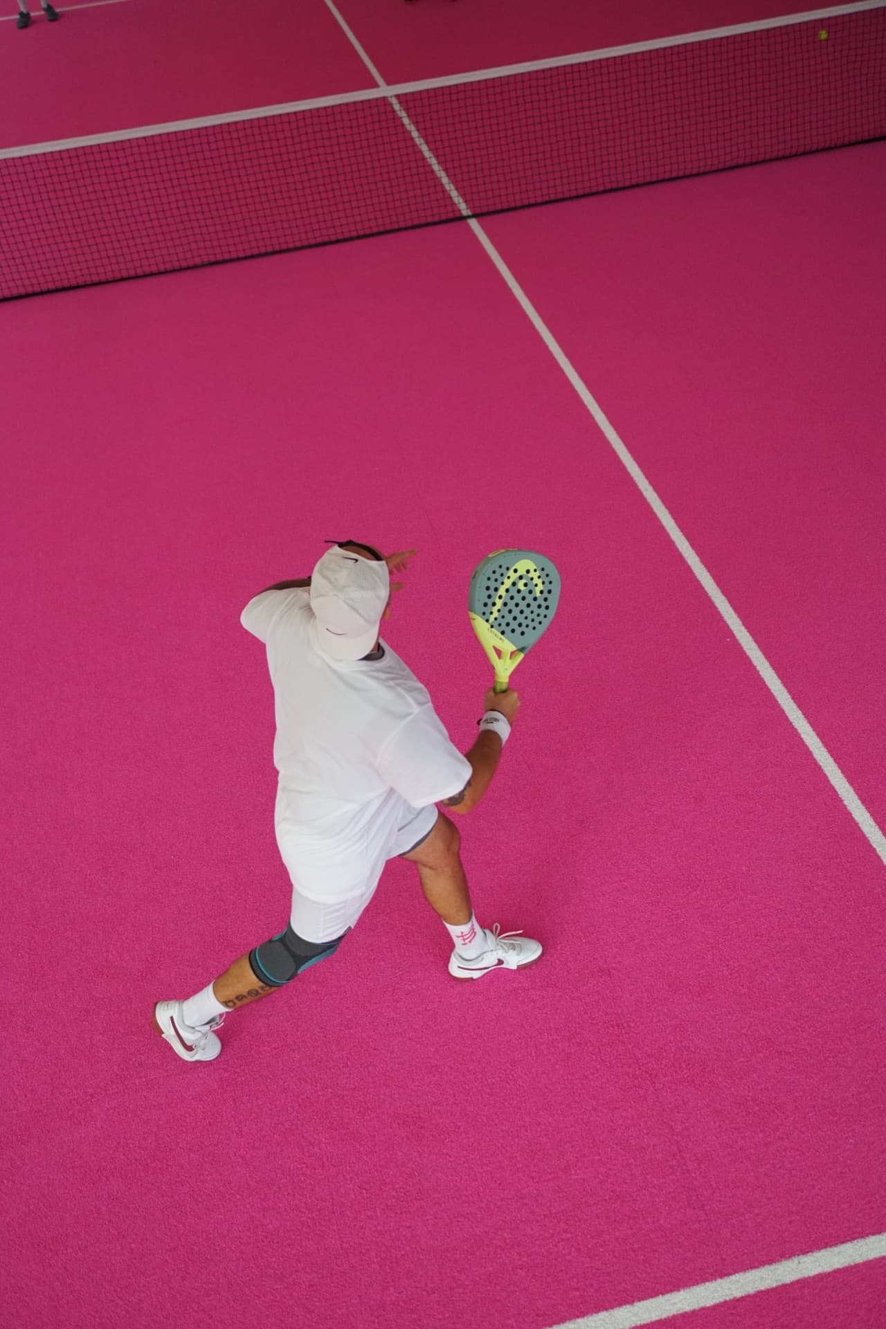 Player serving on the Good Story padel court